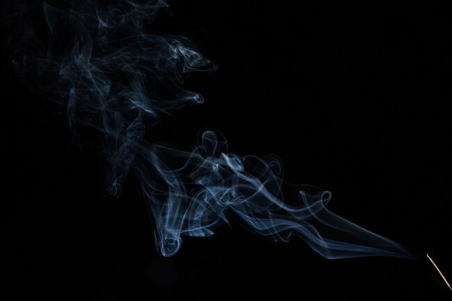 smoke drifting across a black background
