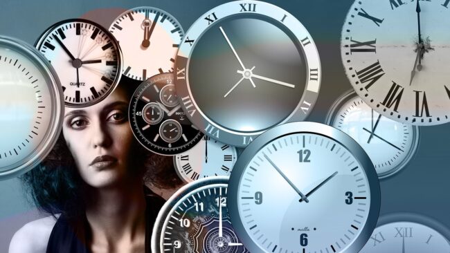 woman's head surrounded by clocks
